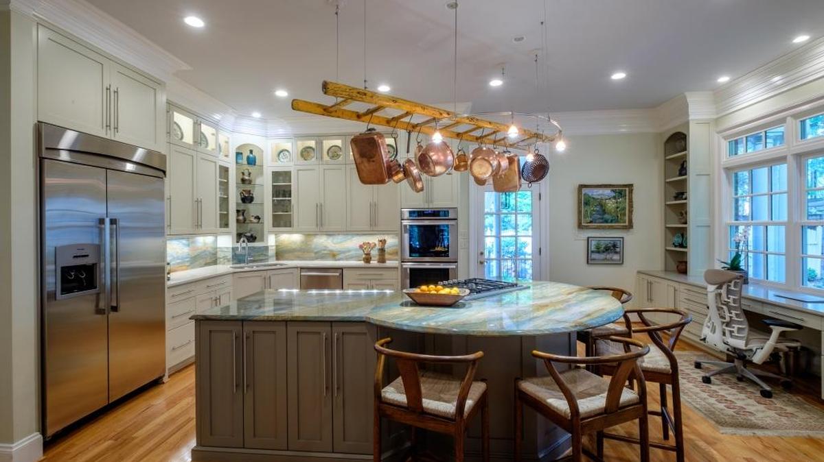 
World travelers 
“Our travels around the world bring such color into our lives,” said the owner of 2327 Hopedale Ave. “The quartzite from Brazil on our kitchen island and backsplash is the template for every color in our home.” The home was built in 1988 and the kitchen remodeled by Charlotte In-Vironments and Jeanine Devaney in 2012. Craftsman Construction was the contractor. A clever touch: A repurposed antique ladder from England hangs above the island to hold copper pots and cookware. 






