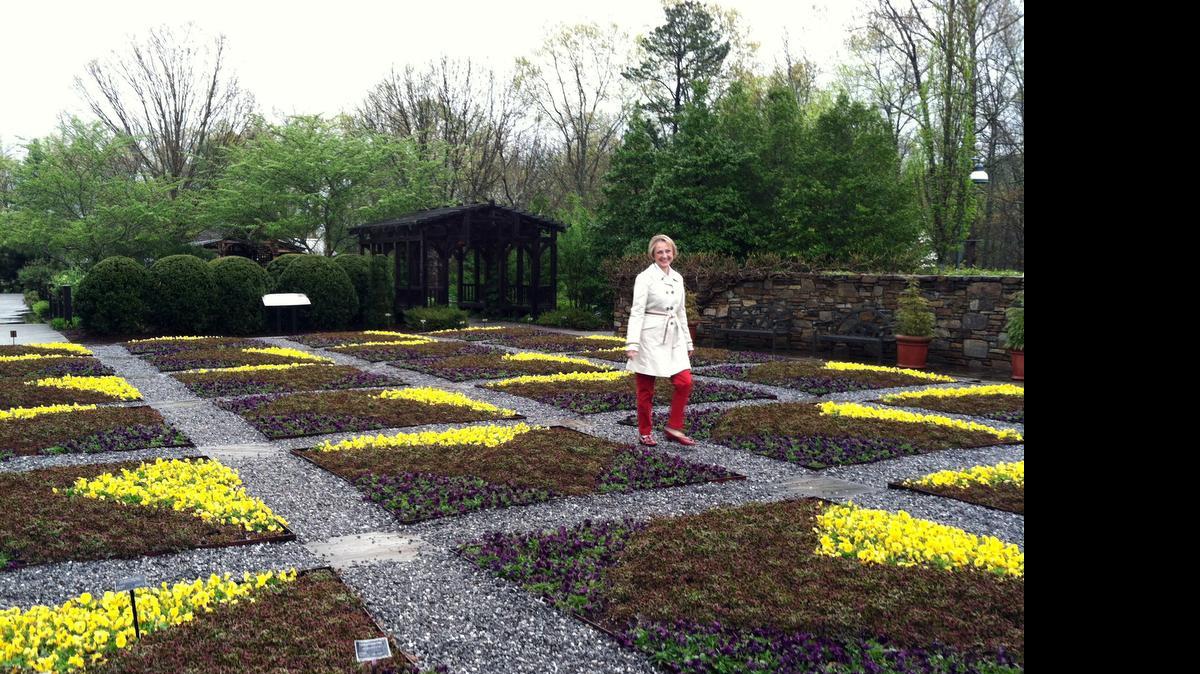
This April 20, 2015 photo shows Clara Curtis, director of design and education at the North Carolina Arboretum in Asheville, N.C., walking in the arboretum's quilt garden. The garden is planted each year in the design of a traditional quilt block pattern to connect the garden to the region's Southern Appalachian heritage.
