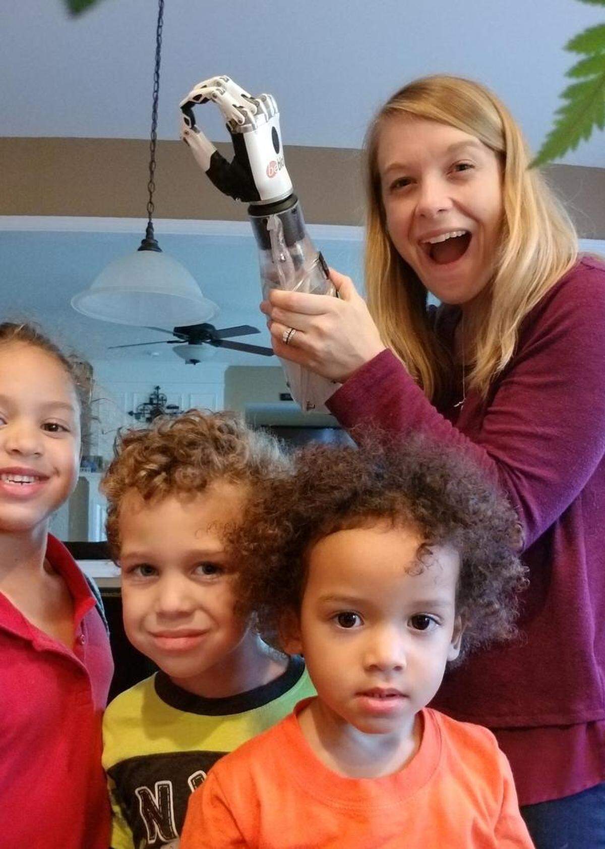 Tiffany Johnson poses with her children and her first myoelectric-controlled prosthesis in November 2017.