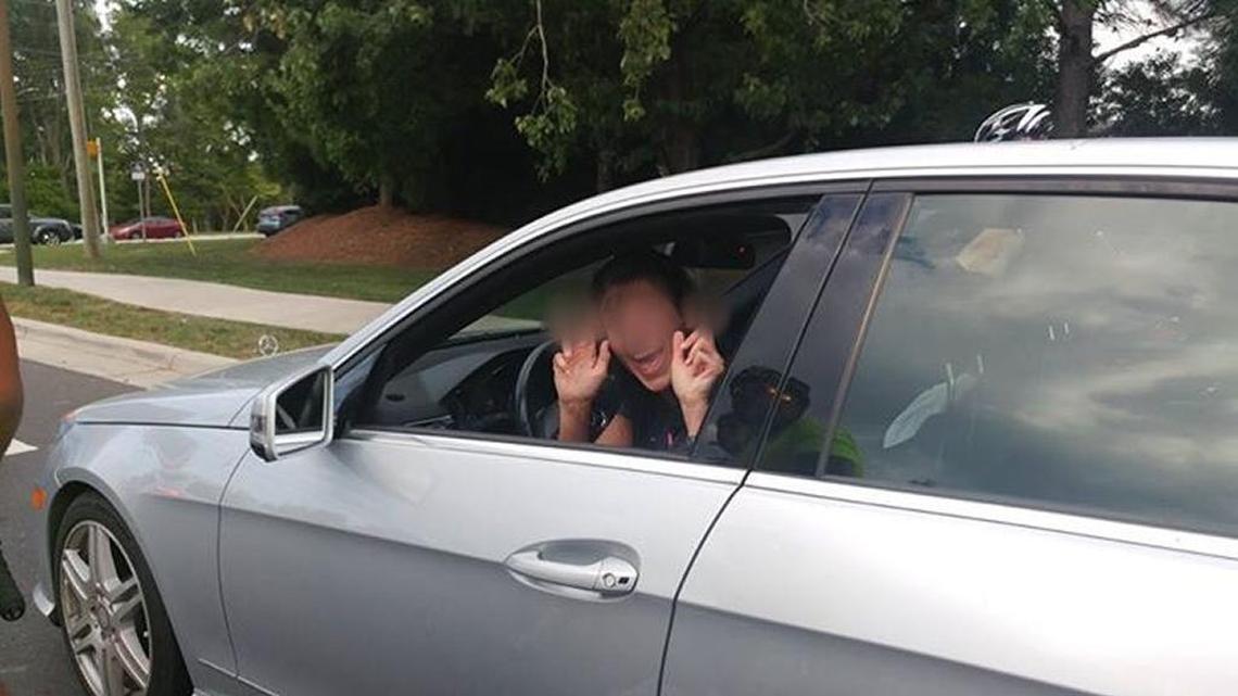 A woman gives the middle finger to a cyclist after a run-in with the group in Ballantyne, NC, in 2016.