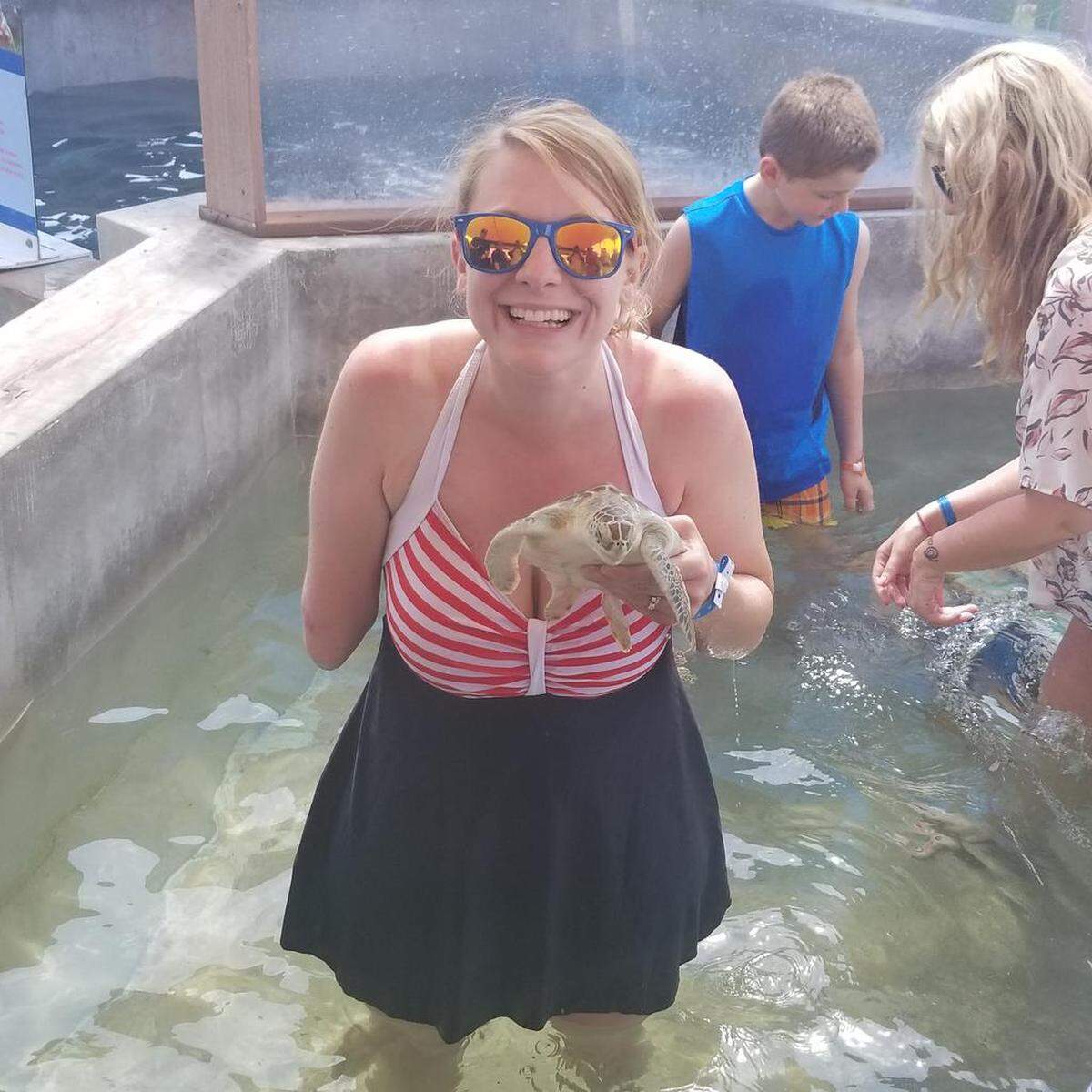 Tiffany Johnson wades in a pool at the Cayman Turtle Centre in Grand Cayman, where she snorkeled (in April 2018) for the first time since the attack.