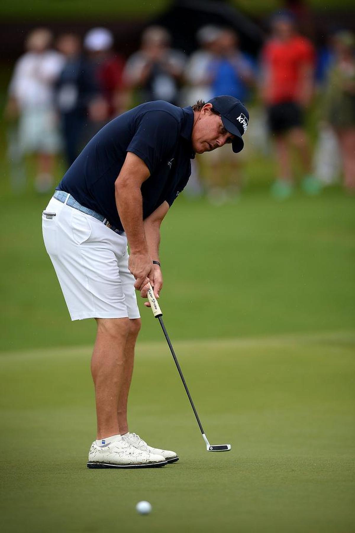 Phil Mickelson putts on the number five green at Quail Hollow Club during practice for the PGA Championship.