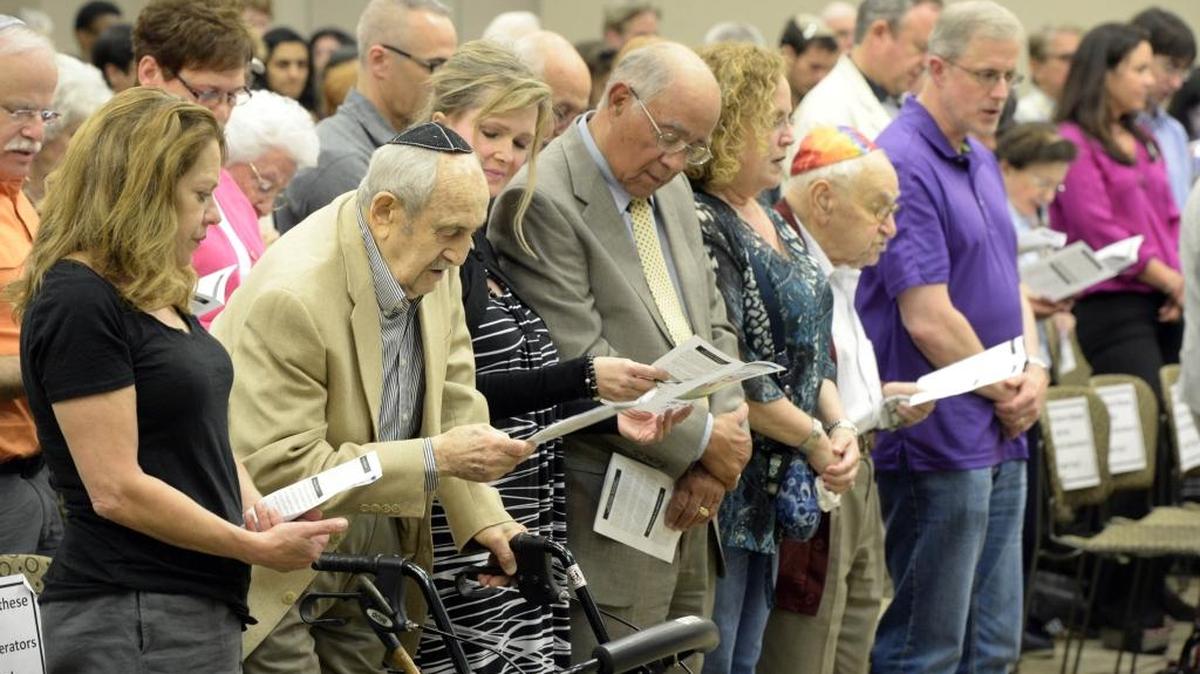 
Audience members participate in the memorial service of the Community Holocaust Remembrance Day in the Sam Lerner Center for Cultural Arts at Shalom Park on Sunday, April 12, 2015.
