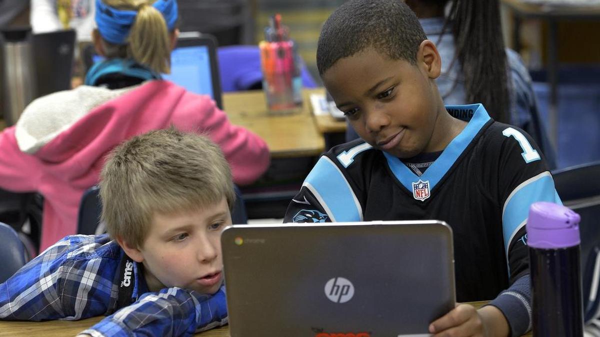 Fifth-graders Connor Black and Dion Clark work at Barringer Academic Center.