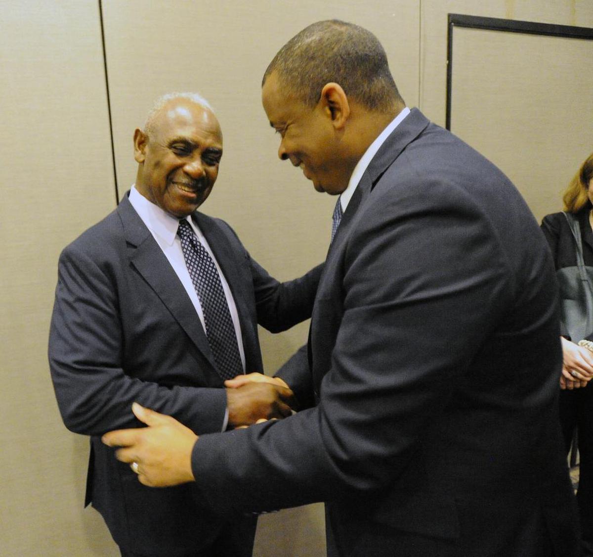 U.S. Transportation Secretary Anthony Foxx, right, greets former Charlotte mayor Harvey Gantt.