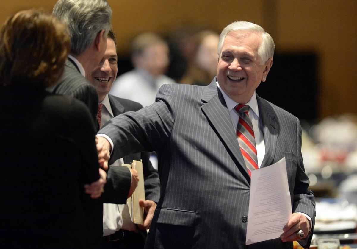 Leon Levine, right, jokes with Larry Sprinkle after the Goodwill Industries of the Southern Piedmont's 50th Cornerstone Celebration at the Charlotte Convention Center in 2015.