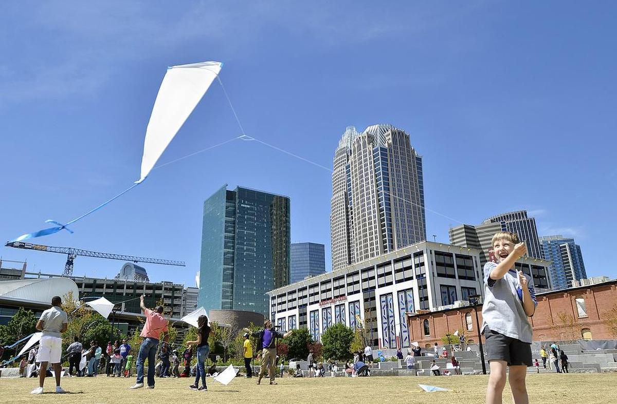 Eight-year-old Jordan Koonce was able to fly his kite with the help of his grandfather, David Preston, in First Ward Park.