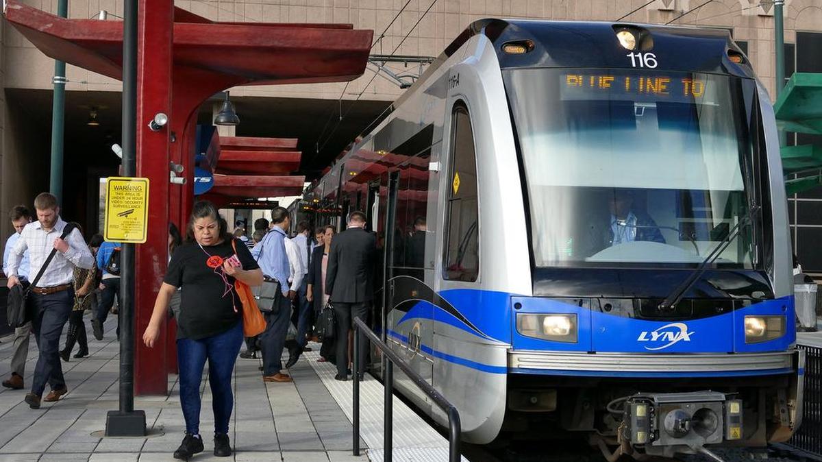 Folks disembark at the 3rd Street/Convention Center light rail station in Charlotte.