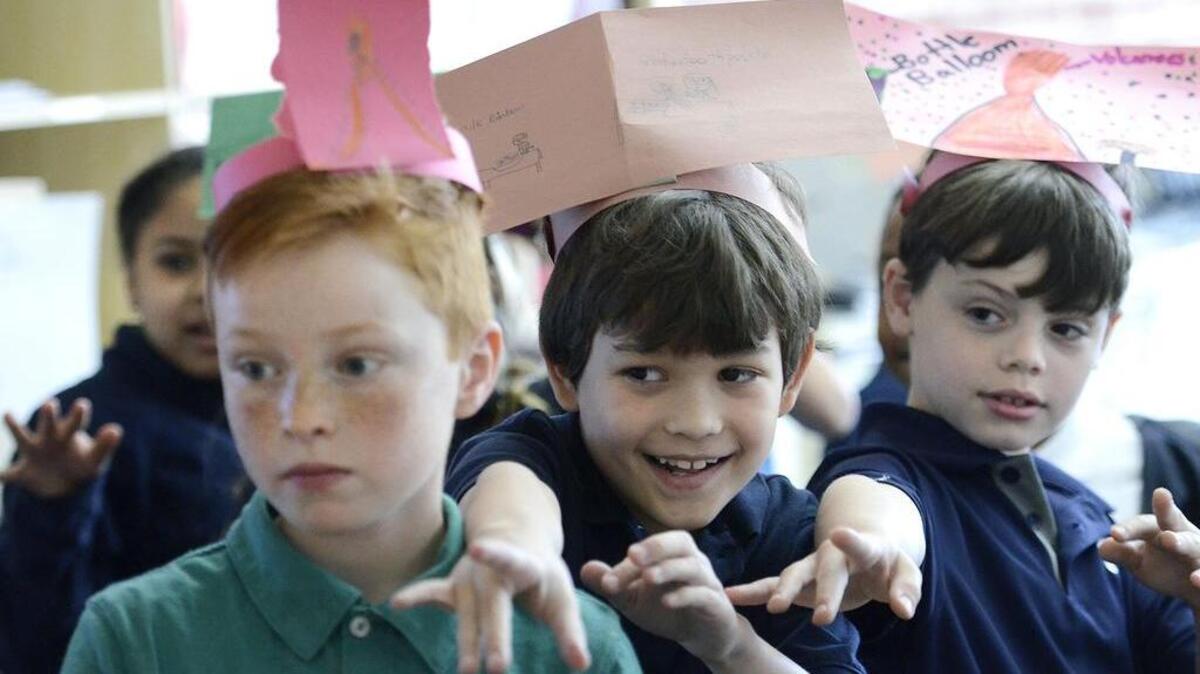 Charlotte Lab School second graders Lauten Mehalic, Henry Brooks and Chandler Sloan “show some love” to a fellow student.