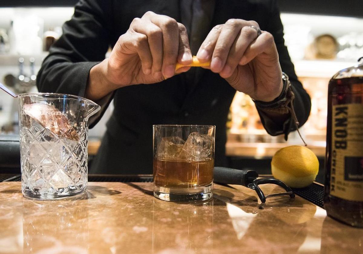 DiSean Burns, bar manager at Stoke Bar at the Marriott City Center, makes a drink.