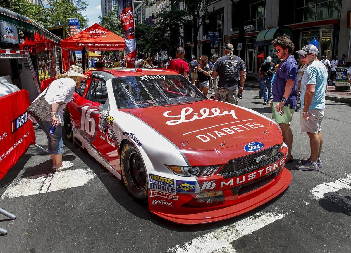 Rick Wiethorn (left) and his son, Nick, admire a race car on display during Speed Street in May 2017.