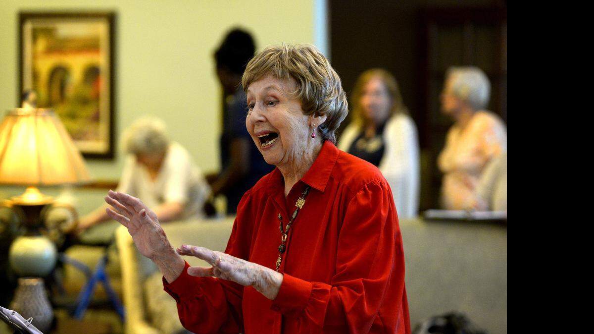
Pearl Rosenthal, 91, leads the Carriage Club Chorus. “Enunciate, look happy, breathe,” she tells them.  She started the chorus four days after moving into Brookdale Carriage Club in May 2008. 

