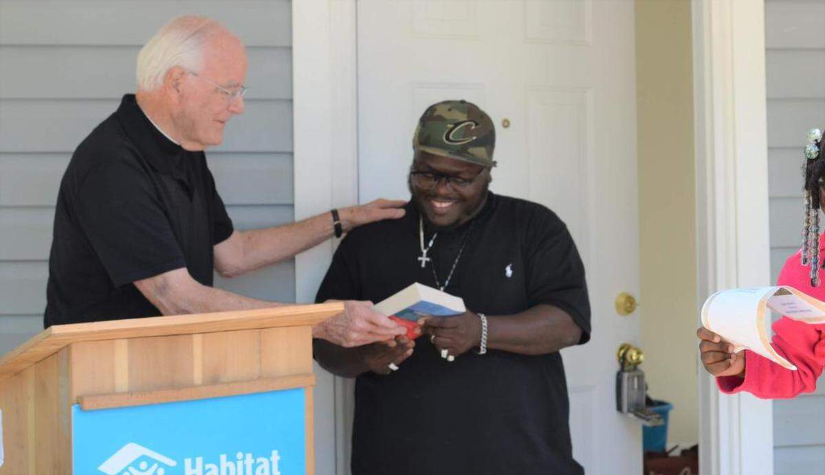 Father Frank O’Rourke at the dedication of St. Gabriel Catholic Church’s most recent Habitat for Humanity home build.
