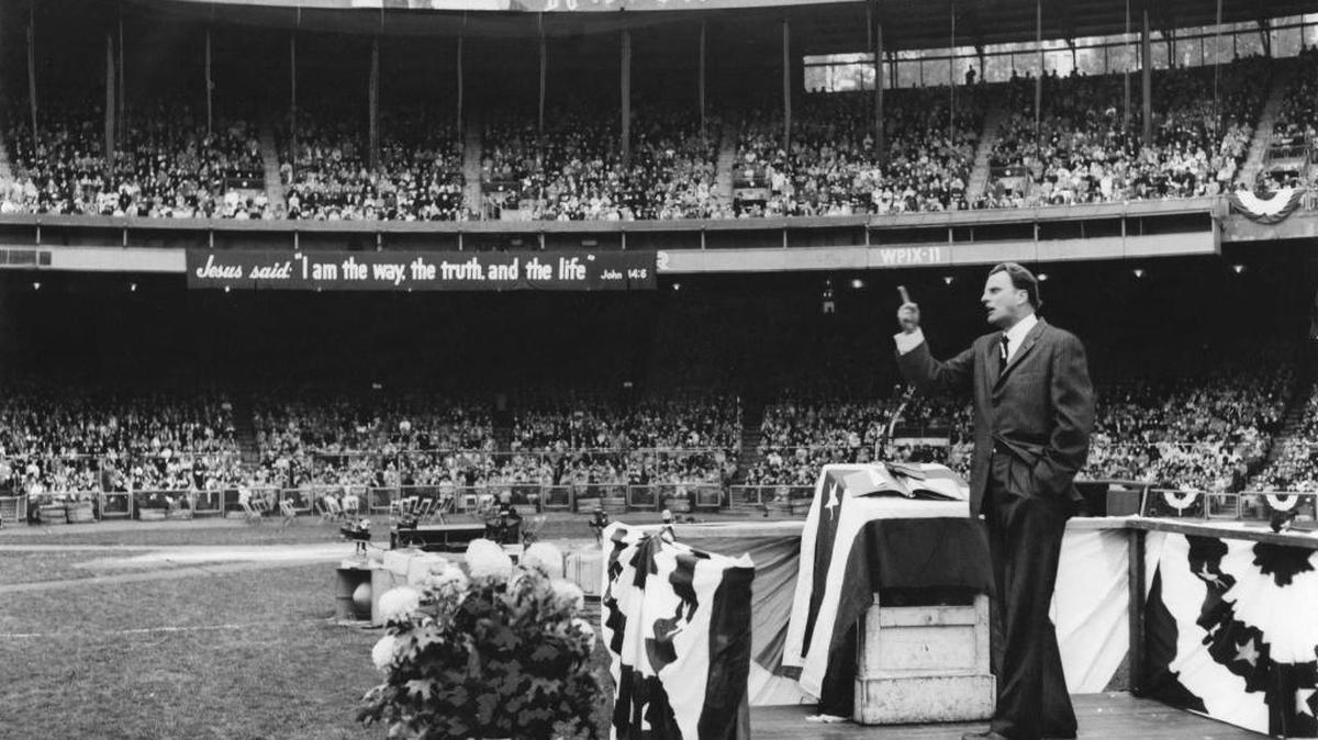 The Rev. Billy Graham speaks at the Polo Grounds in New York, Oct. 27, 1957. He is known for his crusades, but his influence went far beyond.