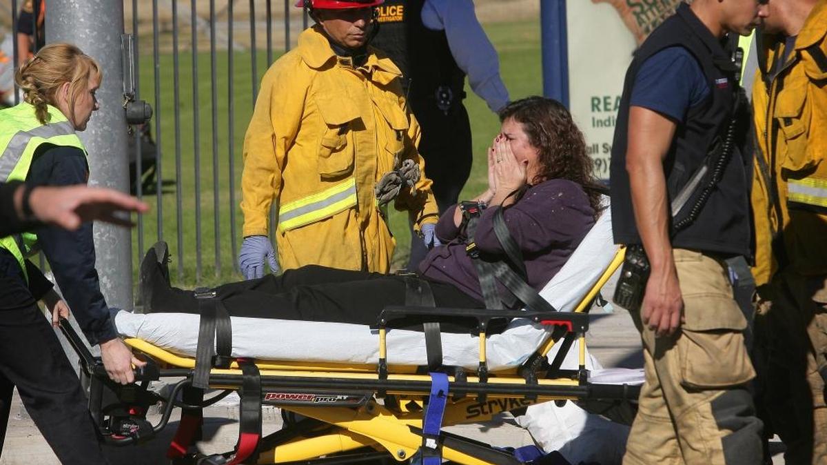 A victim is wheeled away on a stretcher following a shooting that killed 14 people at a social services facility Wednesday in San Bernardino, Calif.