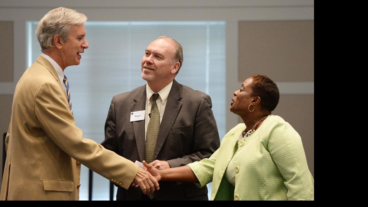 
Pete Peery, interim pastor at Myers Park Presbyterian Church, shakes hands with C. Renee Jarrett before the start of "We Need to Talk Community Conversations for Healing & Change" held at Myers Park Presbyterian Church Oxford Hall July 6
