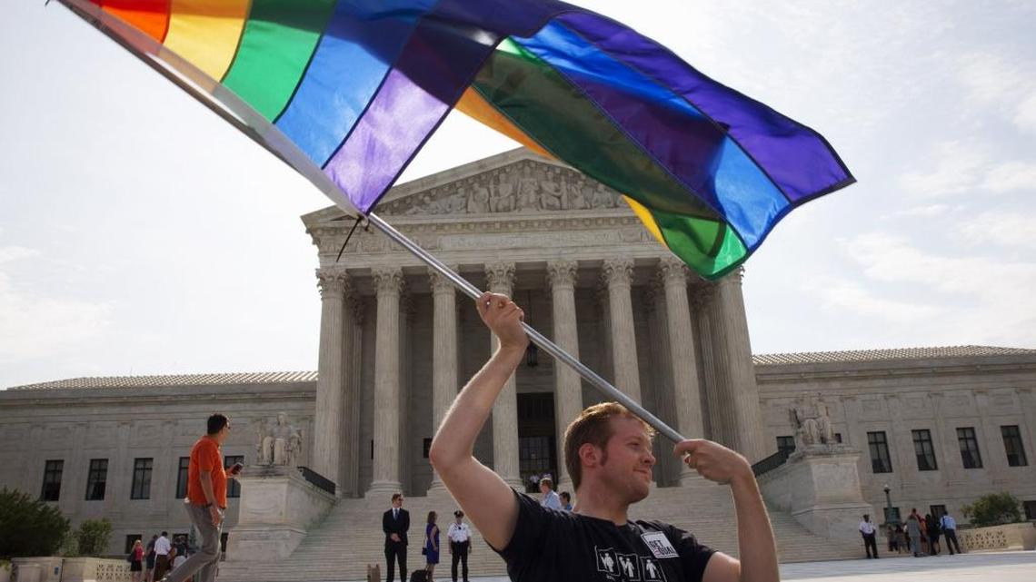 A 2015 file photo shows a gay marriage supporter waving a rainbow flag outside the United States Supreme Court in Washington D.C.