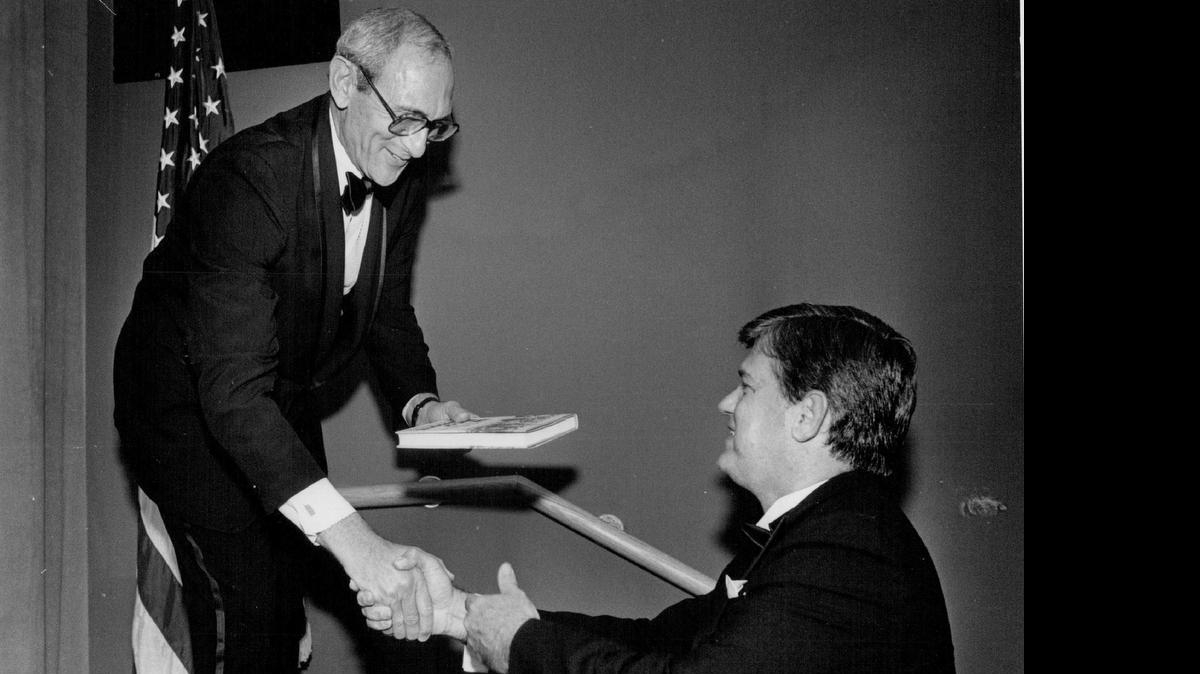 
Mark Bernstein of the Foundation of the Charlotte Jewish Community presents Gov. Jim Martin with a book, “The Jews of Charlotte” by Morris Speizman, at a dedication ceremony for Shalom Park in September 1986.

