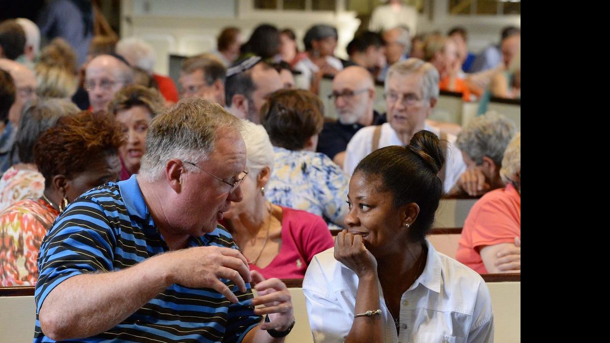 
From left, Tim Johnson of Charlotte and Tracie Watson of Charlotte participated in MeckMin’s first “We Need to Talk” gathering, last month in Belk Chapel at Queens University of Charlotte. The discussions, launched in the wake of the Charleston shootings, are continuing every Monday night through August 31. The next one is Monday, July 13, at Johnson C. Smith University.
