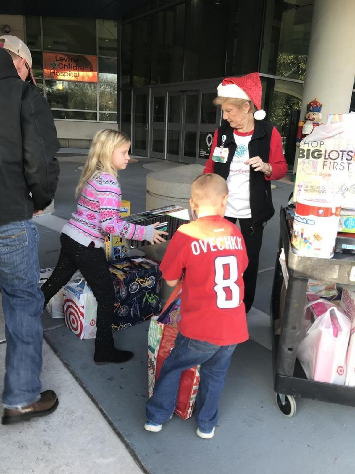 9-year-old Madelyn Huffman, left, delivers donated toys to Charlotte’s Levine Children’s Hospital.