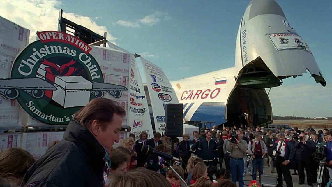 The Rev. Ross Rhoads gave the invocation during a December 1995 send-off ceremony before the Samaritan’s Purse Operation Christmas Child relief flight departed from Charlotte Douglas International Airport.The plane was headed to deliver Christmas gifts to Bosnian children.