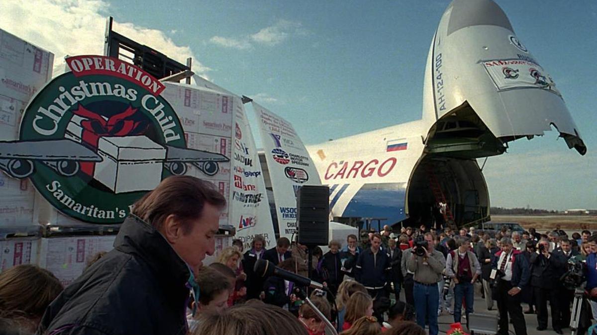 The Rev. Ross Rhoads gave the invocation during a December 1995 send-off ceremony before the Samaritan’s Purse Operation Christmas Child relief flight departed from Charlotte Douglas International Airport.The plane was headed to deliver Christmas gifts to Bosnian children.