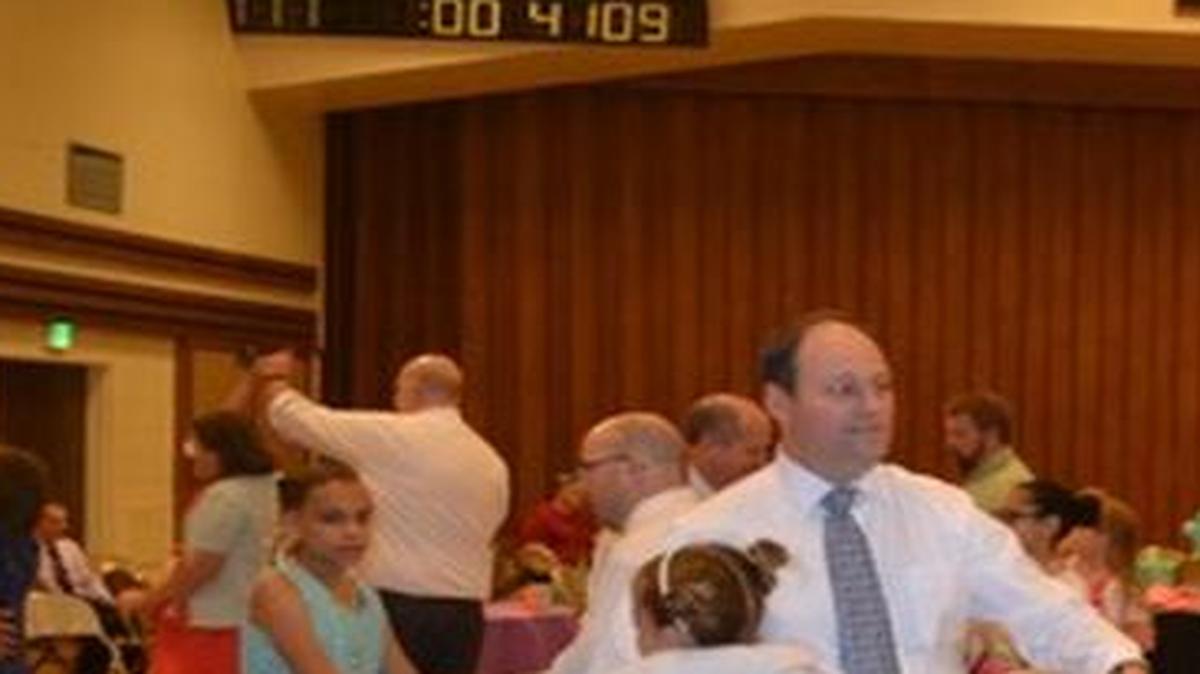 In preparation for the first daddy-daughter dance for members of The Church of Jesus Christ of Latter-day Saints, girls from each congregation made decorations for the table they would share with their fathers. They also made desserts to share at the dance. The DJ for the event was Cici Brown, 13.