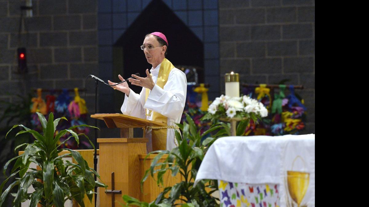 
Bishop Peter Jugis, speaking here in 2014, has been a leading opponent of same-sex marriage. But the 46-county Catholic Diocese of Charlotte, which he heads, has no plans for now to stop banking at Wells Fargo, a gay friendly bank that drew Franklin Graham’s ire last week for its national ad featuring a lesbian couple.
