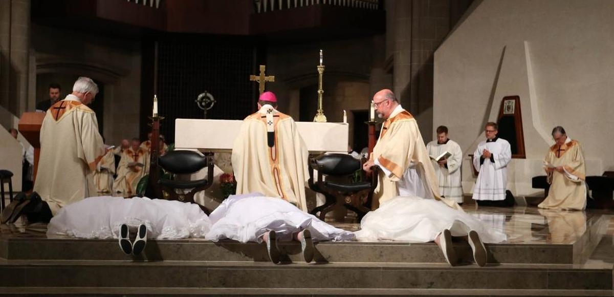 In an especially powerful part of the service, the women lay prostrate as Archbishop Allen Vigneron and everyone in the church recited the Litany of the Saints.