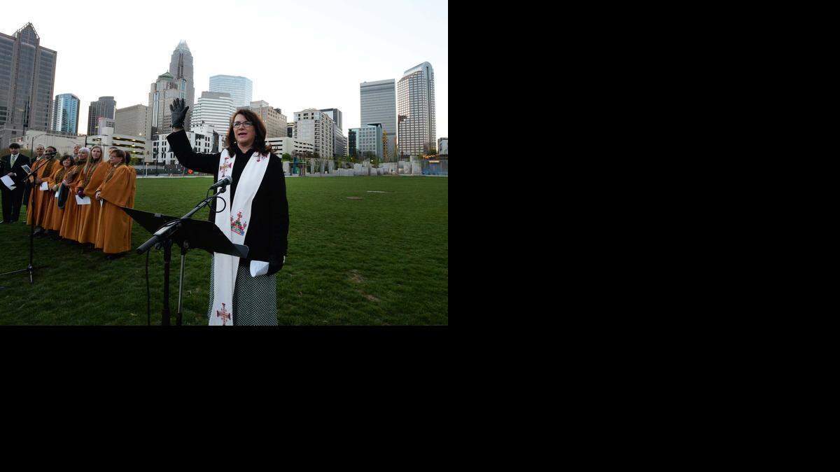 
The Rev. Erika Funk, associate pastor for mission at First Presbyterian Church, delivers the benediction at the sunrise service in Romare Bearden Park early Sunday, April 5, 2015. Members of five churches – Caldwell Presbyterian, Grier Heights Presbyterian, First Presbyterian, First United Presbyterian and St. John’s Baptist – joined together for the uptown service.
