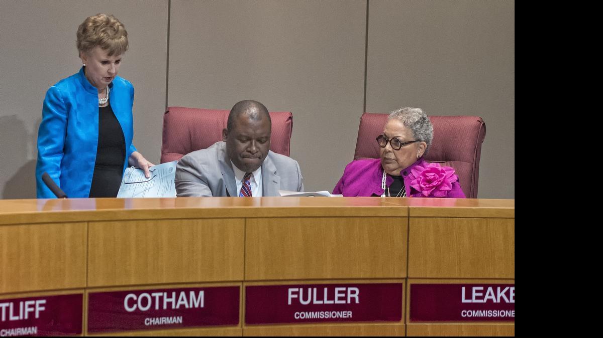 Pat Cotham, left, lost her spot as chairwoman of the Mecklenburg Board of County Commissioners in 2013 to fellow democrat Trevor Fuller, center. Vilma Leake cast the swing vote to elect Fuller. She and Cotham are at odds again today over the opening prayer.