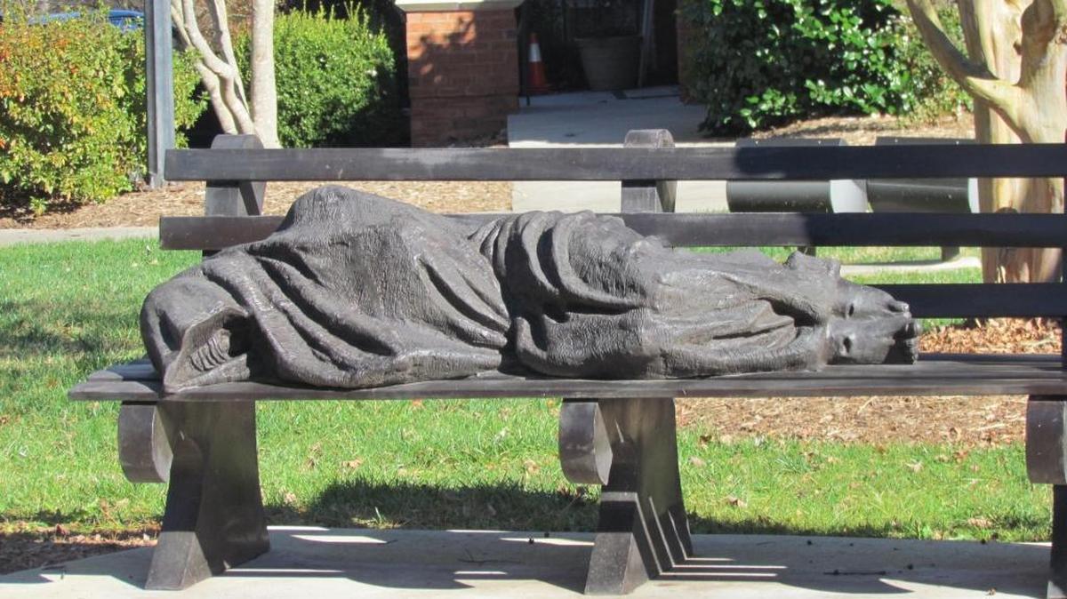 “Homeless Jesus,” a sculpture by Timothy P. Schmalz, went up in Davidson last year outside St. Albans Episcopal Church. It depicts the saviour sleeping under a blanket on a park bench.