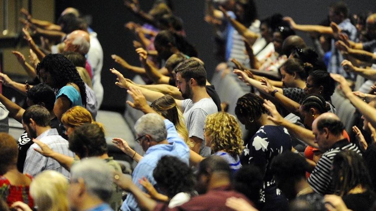 Congregants of Transformation Church in Indian Land pray for Charlotte-Mecklenburg Police Chief Kerr Putney as Pastor Derwin L. Gray leads them during the 8;30 am service on Sunday, July 10, 2016.