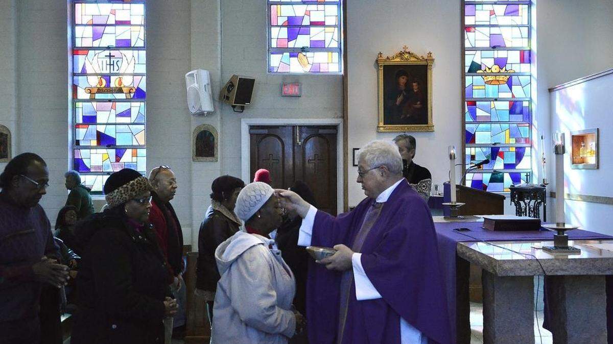 In this file photo, the Rev. Carl Del Giudice applies ashes onto the foreheads of parishioners at Our Lady of Consolation Catholic Church, a predominantly African-American church on Statesville Avenue in Charlotte. Ash Wednesday marks the beginning of Lent for Christians.