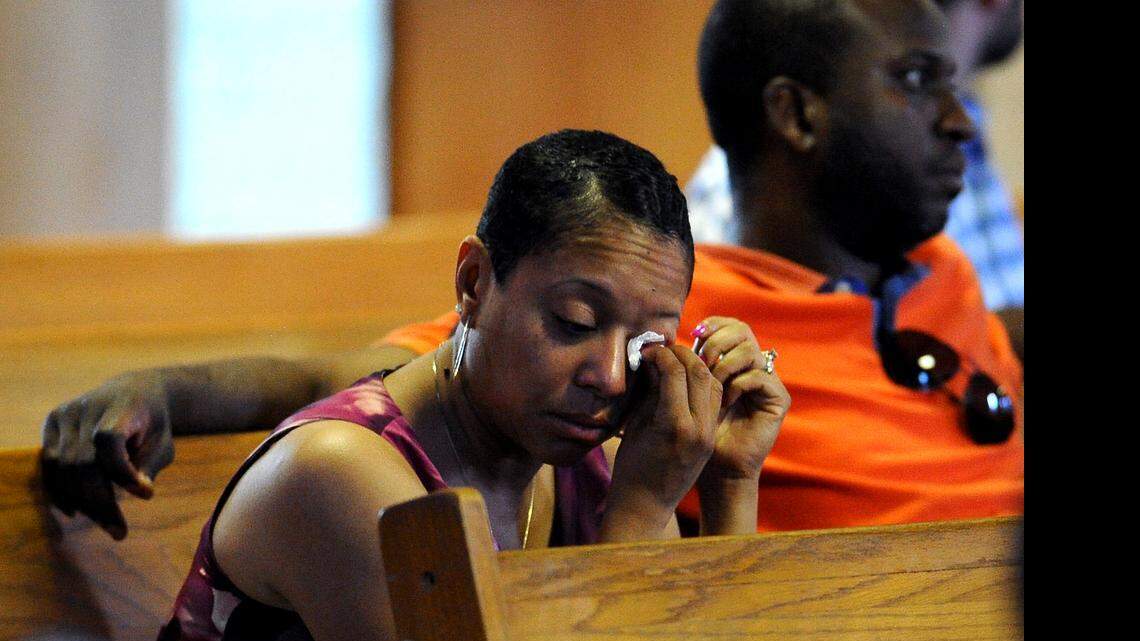 
A woman dabs her eyes during a prayer vigil for the victims of the shooting in Charleston, SC at Little Rock AME Zion Church in Charlotte, NC on Thursday, June 18, 2015. The vigil was sponsored by the Charlotte-Mecklenburg chapter of the NAACP.
