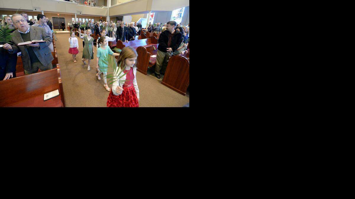 
Children lead a processional waving palm fronds during the start of 11am services at Matthews United Methodist Church on Sunday, March 29, 2015. Palm Sunday, which comes a week before Easter Sunday, recalls Jesus’ triumphal entry into Jerusalem atop a donkey, when palm fronds were thrown before his path. 
