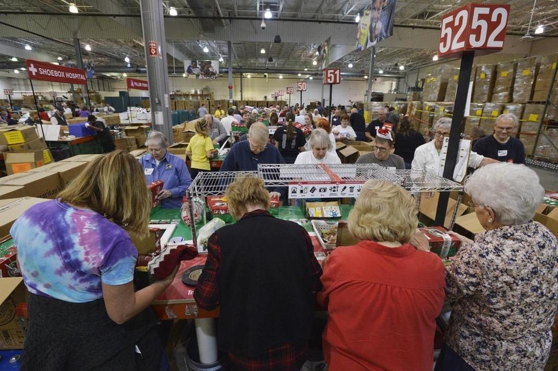 Volunteers sort and pack shoe boxes at the Charlotte warehouse of Samaritan’s Purse, Tuesday, November 28, 2017. Franklin Graham, volunteers and kids gathered at the Charlotte warehouse Tuesday to give Operation Christmas Child a grand local sendoff.