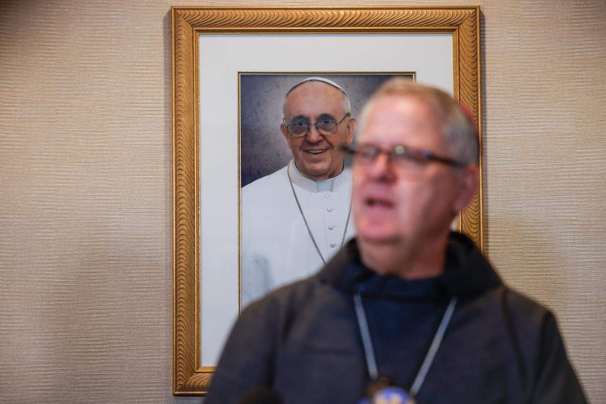 A framed image of Pope Francis hangs on the wall behind Bishop Michael Martin of the Diocese of Charlotte as he addressed the media concerning the Pope’s death during a press conference on Monday. Martin announced that the public is invited to join Catholics in remembering Pope Francis from 7 p.m. to 8 p.m. at Western North Carolina churches across the diocese.