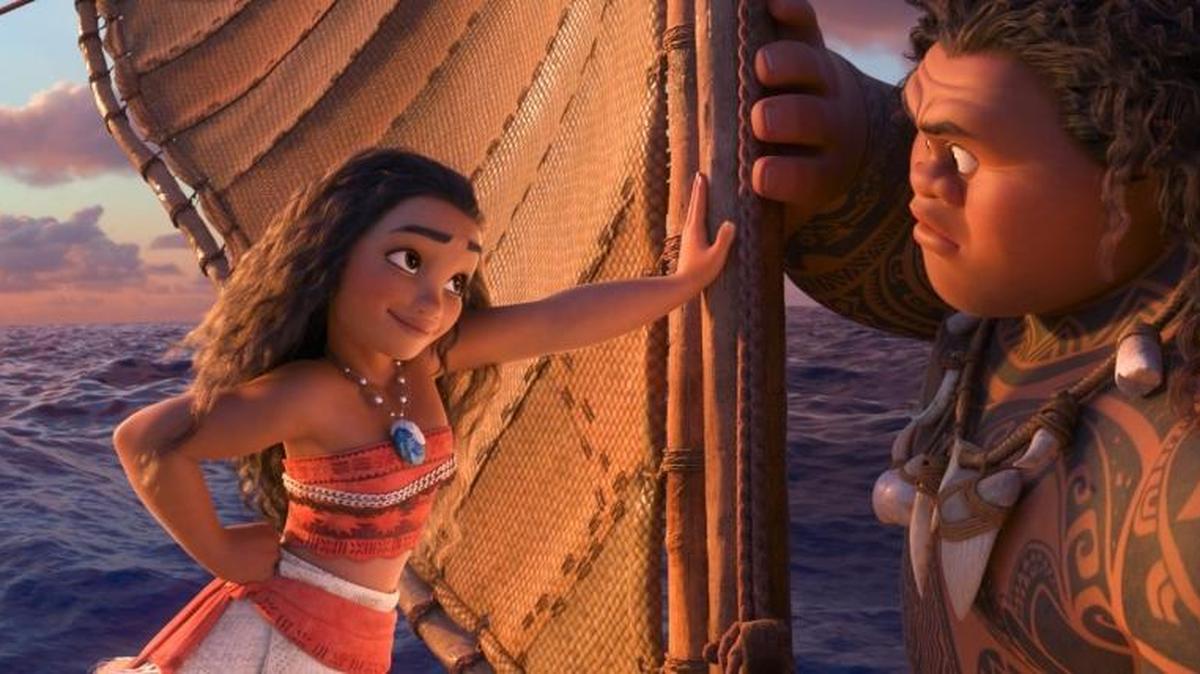 This image released by Disney shows characters Maui, voiced by Dwayne Johnson, right, and Moana, voiced by Auli'i Cravalho, in a scene from the animated film, "Moana."