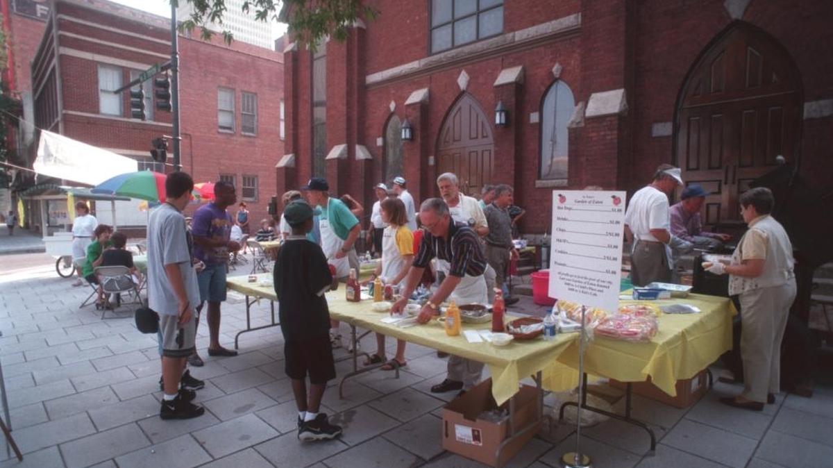 At the Garden of Eaten, members of St. Peter Catholic Church in uptown Charlotte serve up hot dogs prior to a Panthers game in 1998, two years after its launch. All donations from football fans on their way to Bank of America Stadium still go to charities that help the homeless and others.