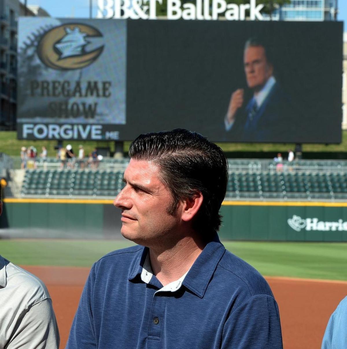 Billy Graham's grandson Will Graham, also an evangelist, recently participated in a salute to his famous grandfather at BB&T Ballpark in uptown Charlotte. Here he watches a video presentation of Billy Graham during an interview before the Charlotte Knights game on “Faith and Family Night” at the ballpark.