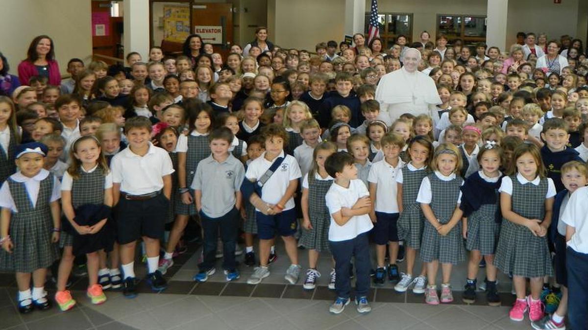 
Students pose with a cardboard cutout of Pope Francis in the school lobby. Saint Gabriel Catholic School enjoyed celebrating Pope Francis’ visit and discussing his message.
