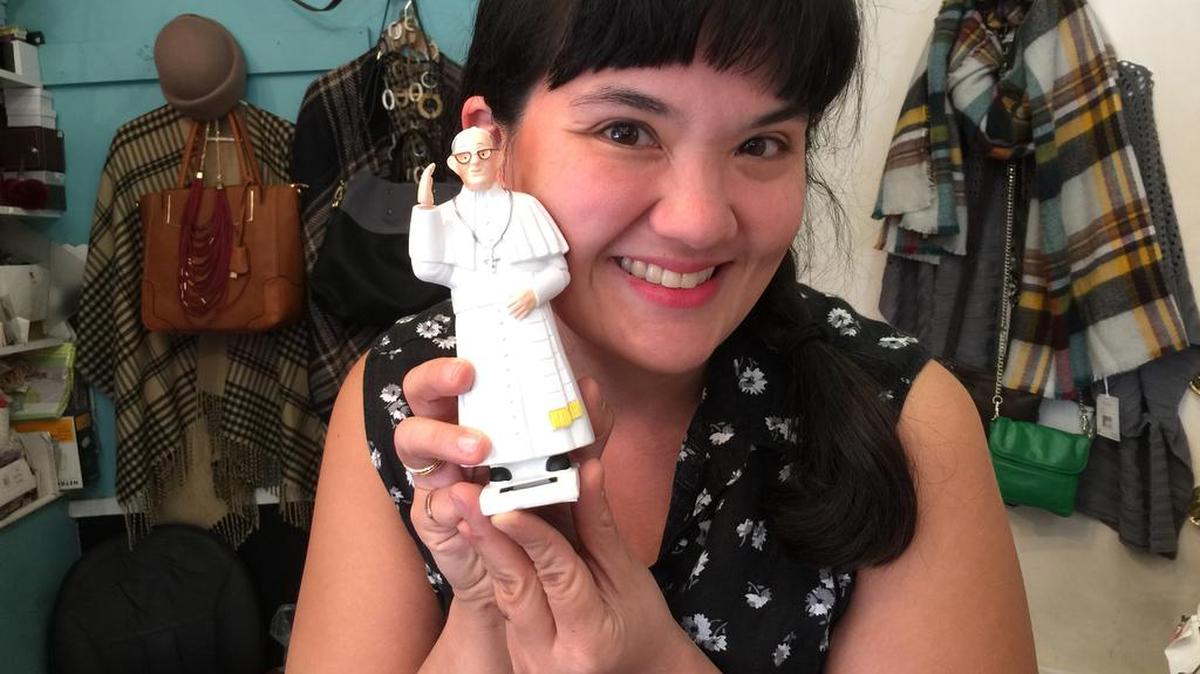 
At Tselaine gift shop in Philadelphia, manager Laura Lewis poses with The Solar Pope. Put it in sunlight and it waves.
