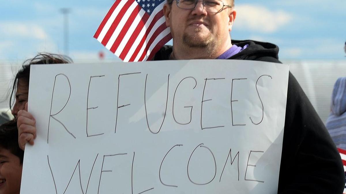 Trevor Curtis protests at the corner of Josh Birmingham and Wilkinson Boulevards in January next to the airport. Protesters gathered to protest President Donald Trump's immigration policy.