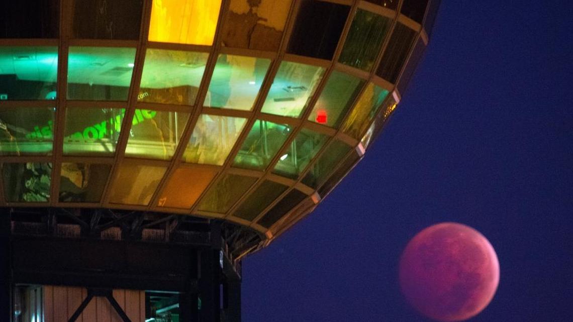 A lunar eclipse dips beneath the Sunsphere in Knoxville.