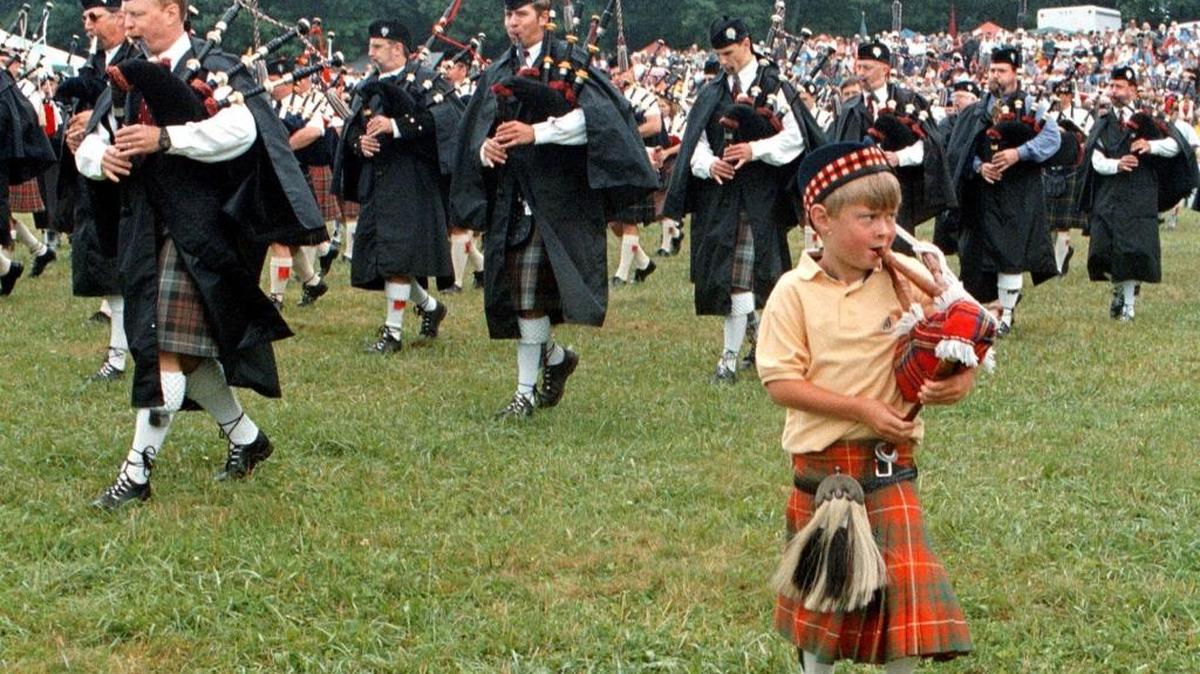 A youngster plays along with the Grandfather Mountain Highland Pipe Band at the Grandfather Mountain Highland Games.
