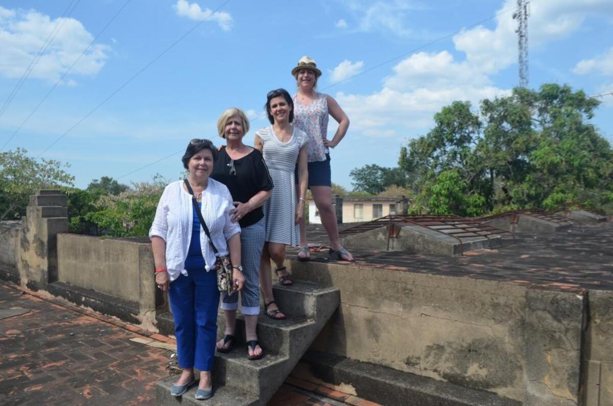 We four travelers recreated an old family photo posed on steps on the roof of my great grandparents’ home in Los Arabos, Cuba.