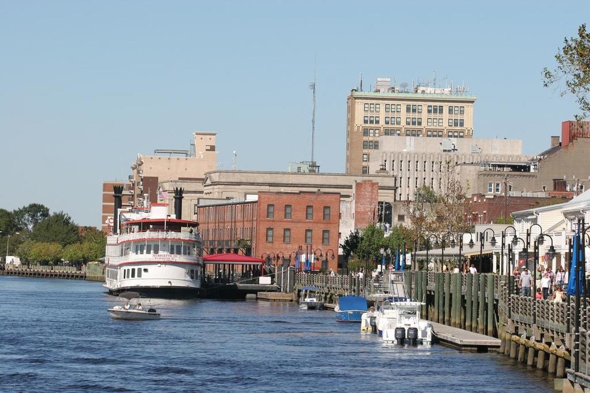 Wilmington is astride the Cape Fear River, with the Riverwalk and downtown on the east bank, shown here, and Battleship North Carolina on the west.