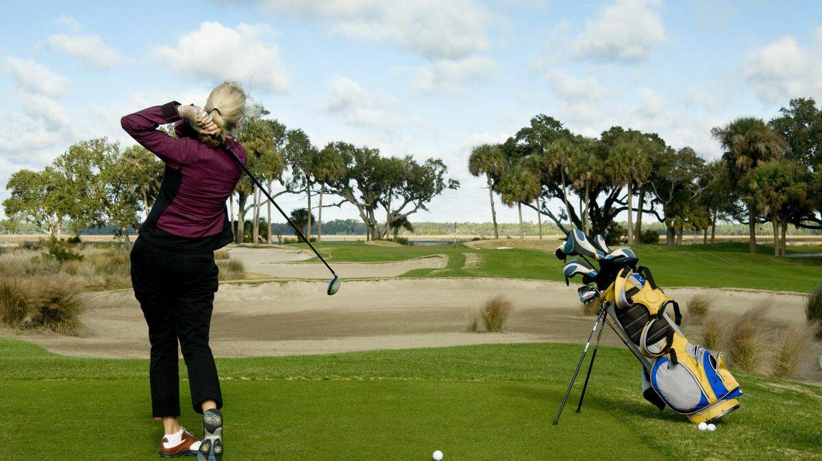 A woman playing golf. 