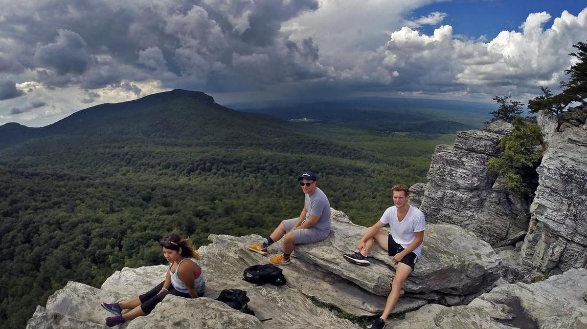 
From left, Riccy Marroquin, Luis Laverde and Ryan Long enjoy a picture-perfect day atop Hanging Rock Wednesday. The high school friends got together to take a break from college activities and reconnect. Hanging Rock State Park, near Danbury is one of North Carolina’s crown jewels with breathtaking views, over 18 miles of trails, camping and a lake with swimming and boating during the summer.
